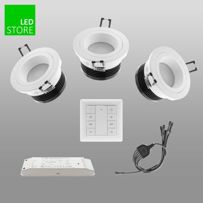 Three white LED downlights, remote control, wires, power supply in grey. Green 'LED Store' logo in upper left corner. Improve your lighting solutions with our products.