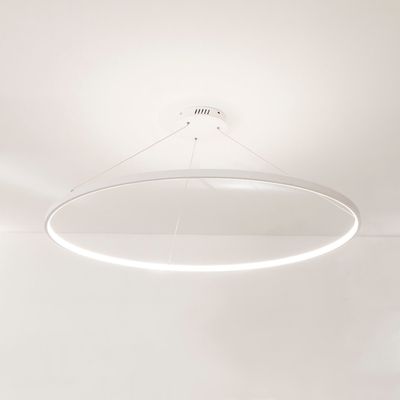 Modern round LED ceiling light, minimalist design, suspended on cables, bright white lighting on a white ceiling.