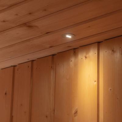A ceiling mounted LED luminaire illuminates the wooden wall panels below.