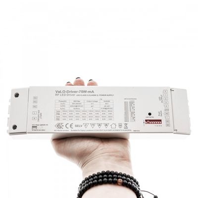 Hand rectangular RF-LED controller with technical labels, settings visible, bead bracelet advertising LED lighting products.