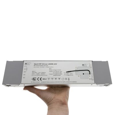 Hand held grey VaLO-RF Driver-200W-24V, displaying input/output data and safety icons for LED lighting systems.