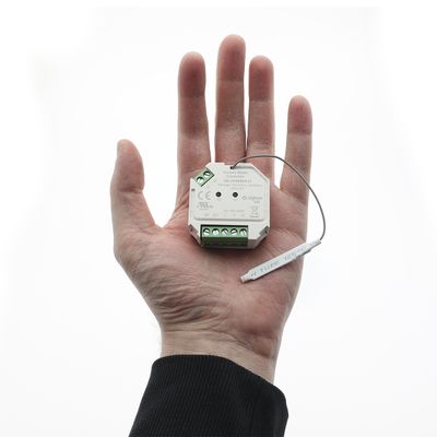"A person holding an LED controller with wires and connectors on a white background displaying electronic components from an LED lighting store.