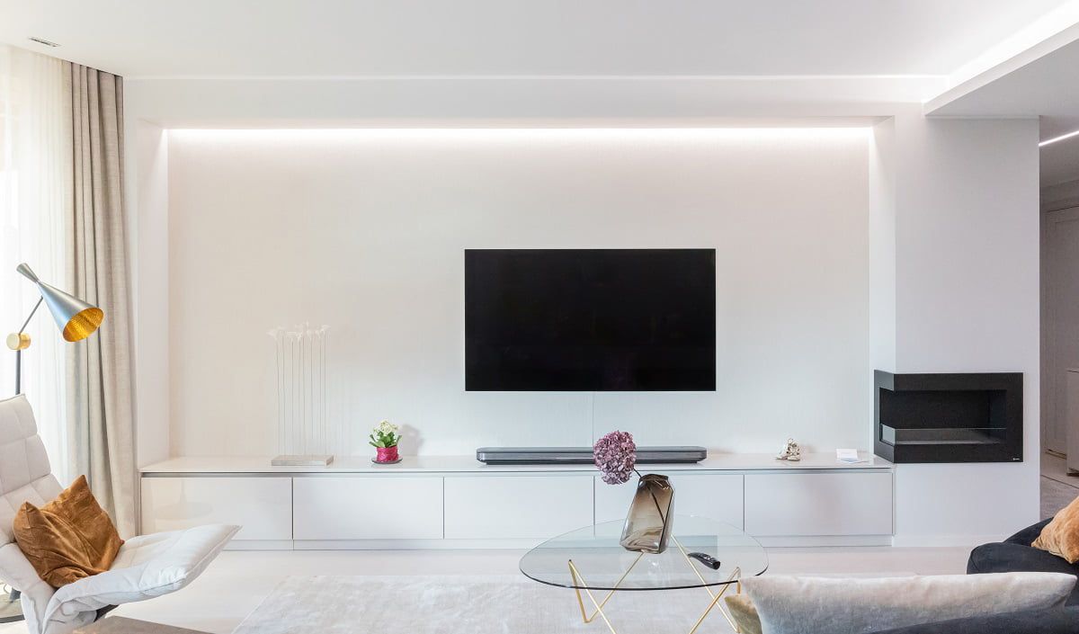 Eye-friendly lighting behind a TV wall with an indirect LED strip in the ceiling groove. © LedStore