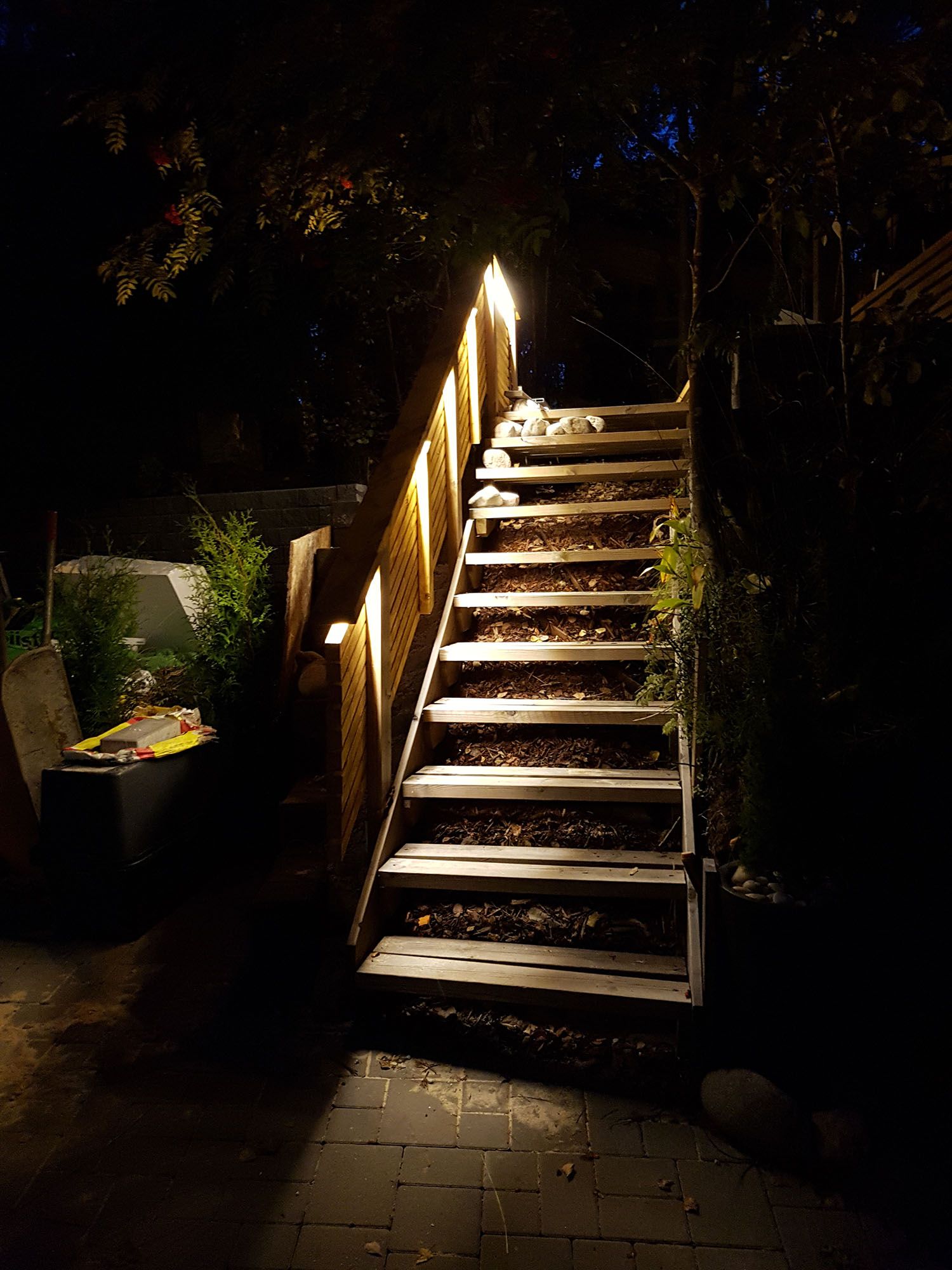 Led strip light outdoors illuminating indirect light on an outdoor stair railing. Ledstore.fi