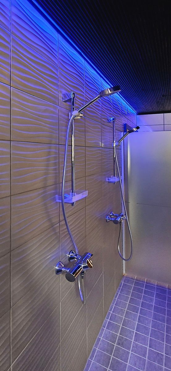 The men\'s side washrooms are illuminated with RGB strip lighting above the showers from the ceiling, photo by the Punchers