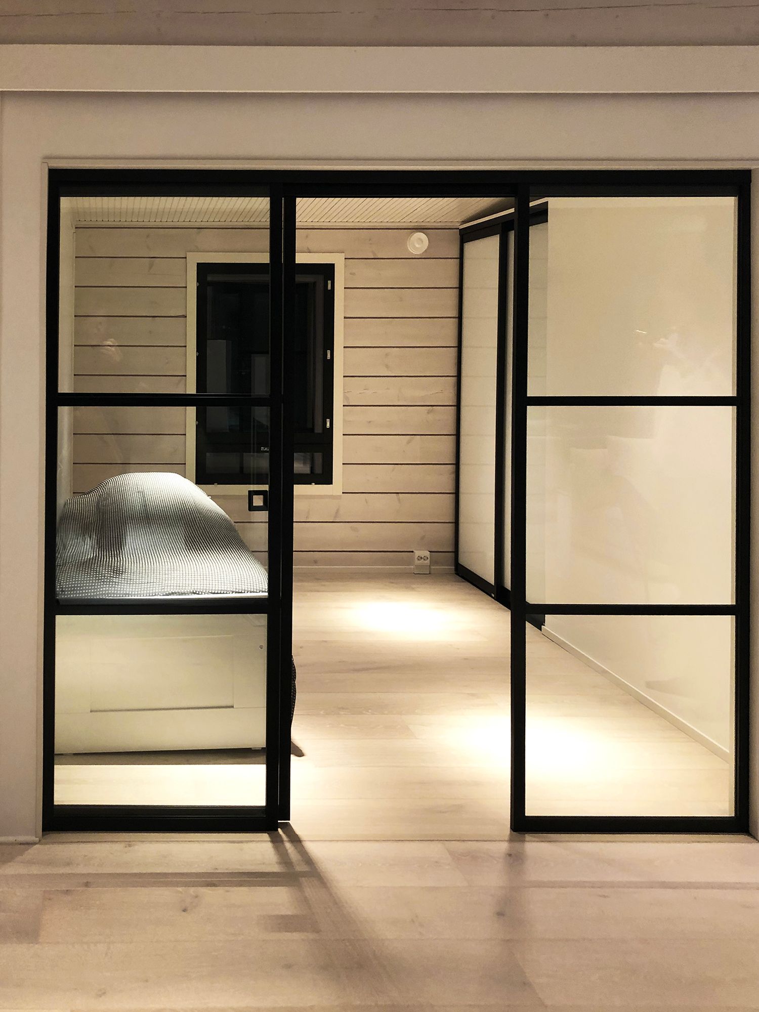 Atmospheric light in the bedroom realized with narrow-angled line lamps that create clear light patterns. Ledstore.fi