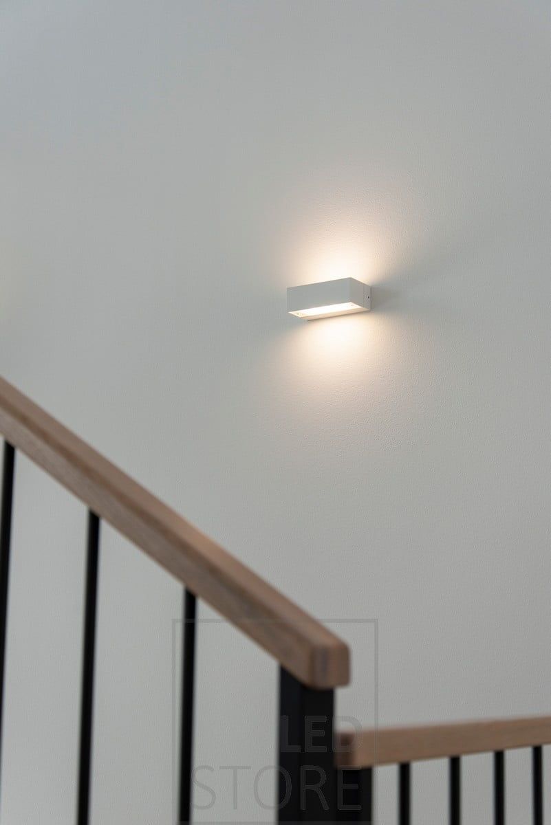 ANGULAR bi-directional wall luminaire in a staircase. Shines through the etched glass with a beautifully soft and atmospheric light. Ledstore.fi