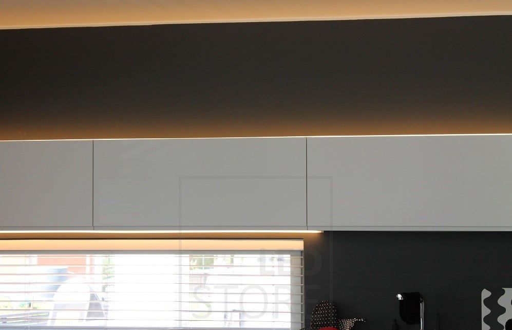 Housing Fair 2014: in the kitchen, an LED strip indirectly illuminating the top of a cabinet and a countertop light mounted on the bottom of the upper cabinet. Ledstore.fi