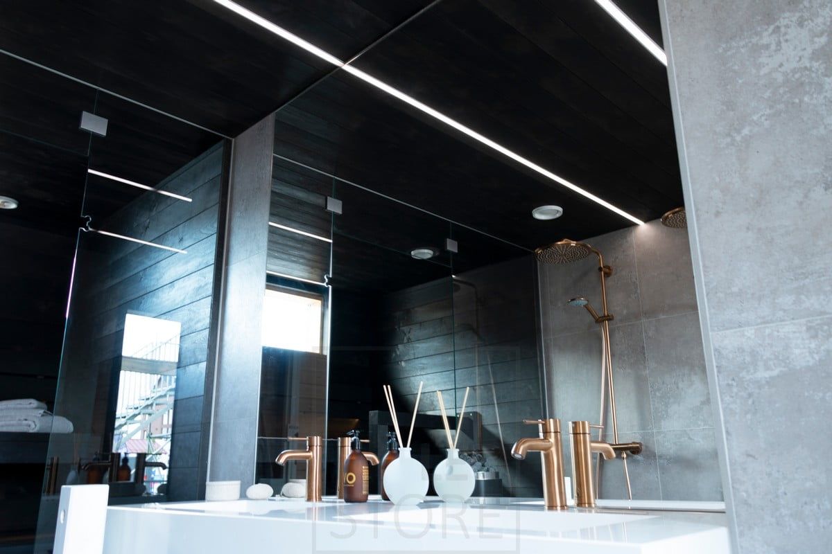 Housing Fair 2020: led strips illuminating the bathroom in narrow recessed profiles in the black ceiling of the washroom. Ledstore.fi