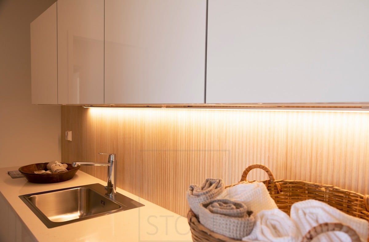 Housing Fair 2020: countertop lighting in the utility room implemented with LED strip. The lighting also highlights the beautiful panelling. Ledstore.fi