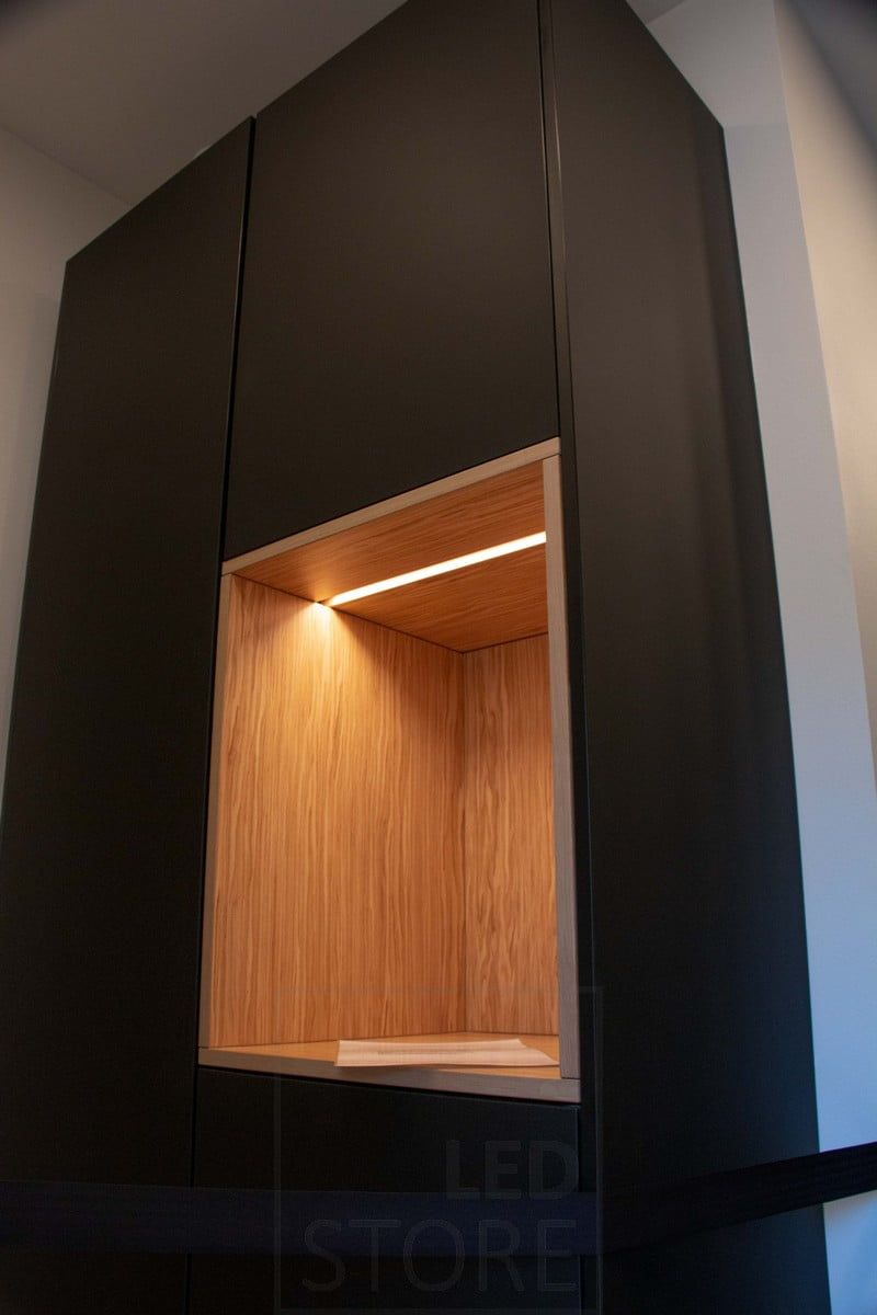 Housing Fair 2022: Led strip light in a narrow recessed profile illuminating an open shelf of a cupboard. Ledstore.fi