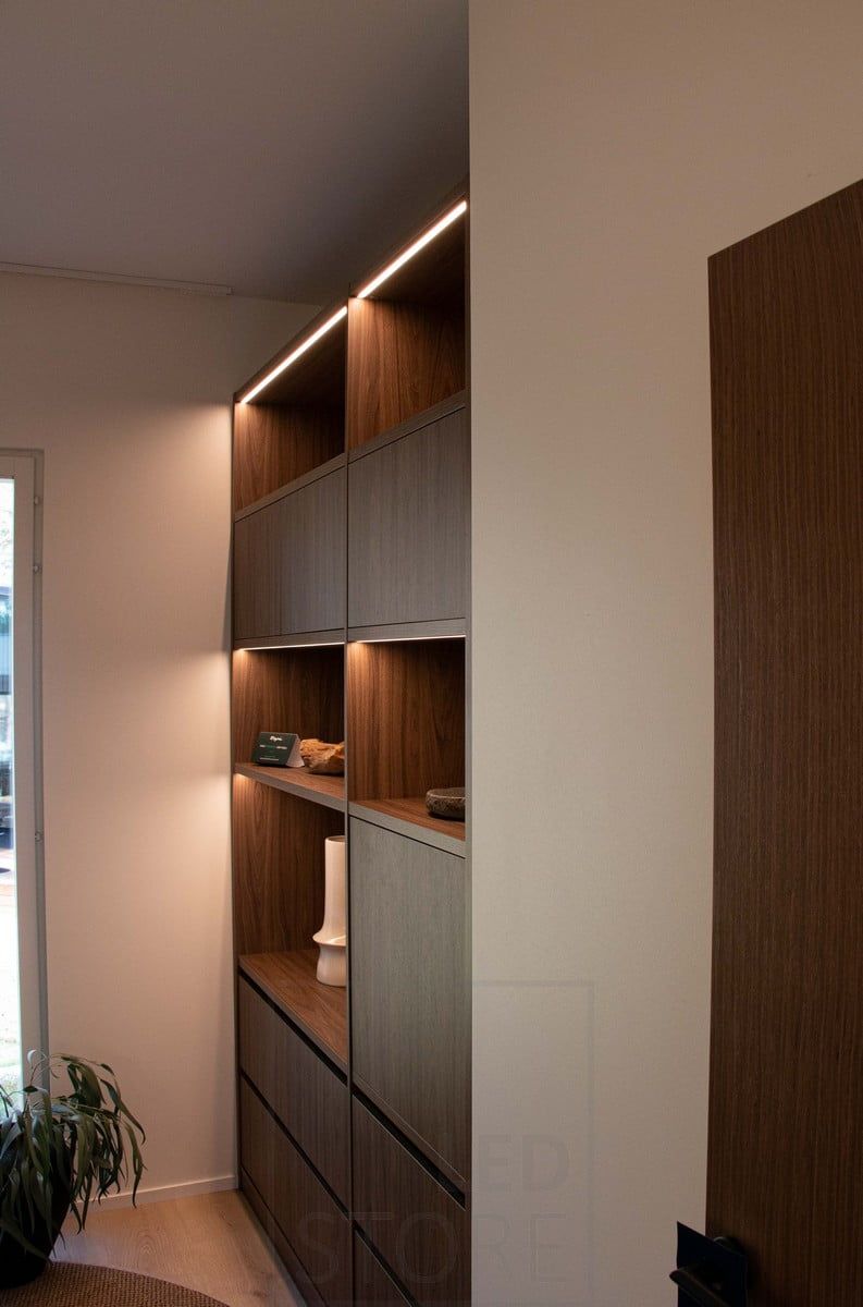 Led strip lights milled on shelves in a narrow flush-mounted profile. Ledstore.fi