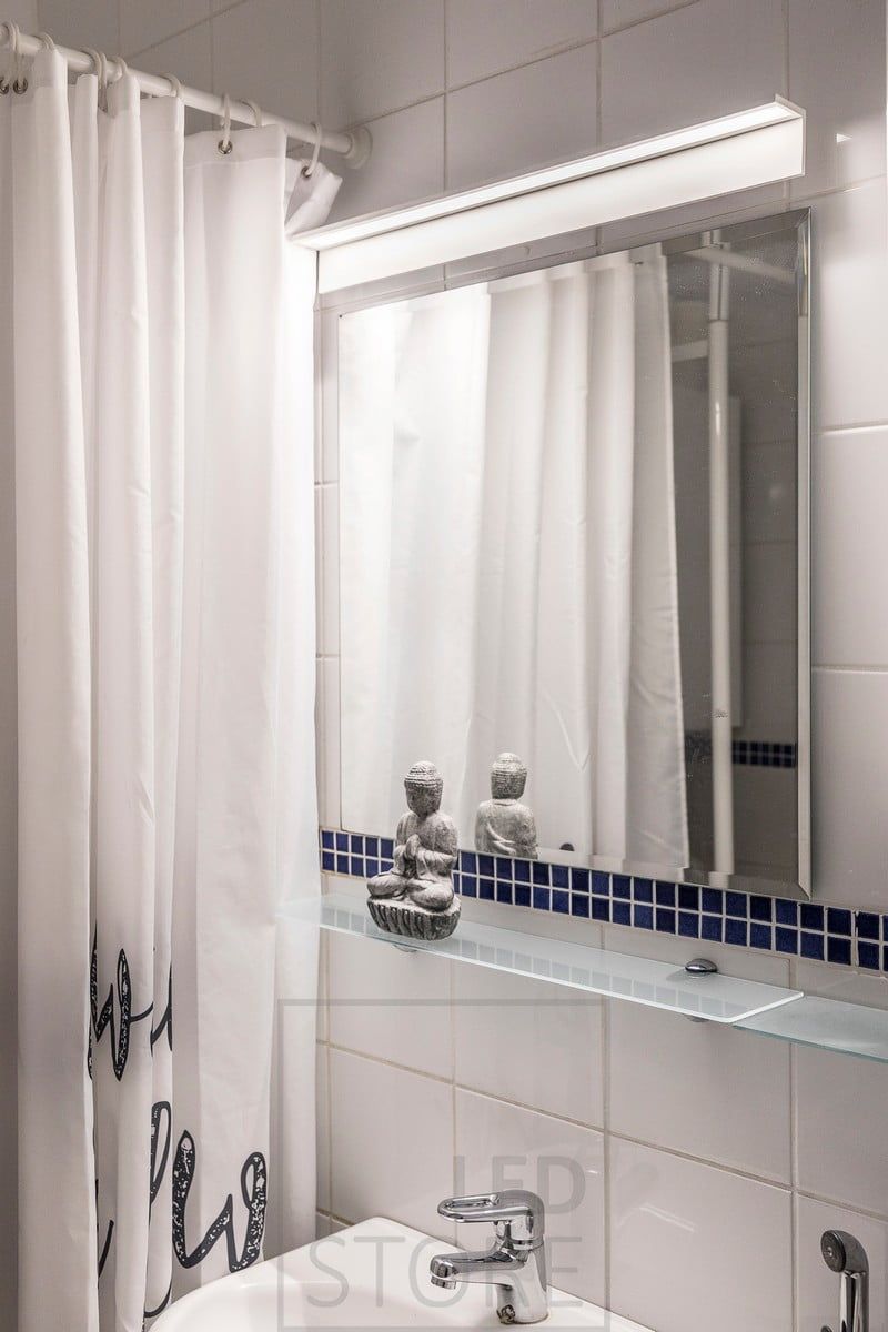 Blade wall lamp above a mirror in the bathroom. The luminaire illuminates well the face as well as the mirror. Ledstore.fi