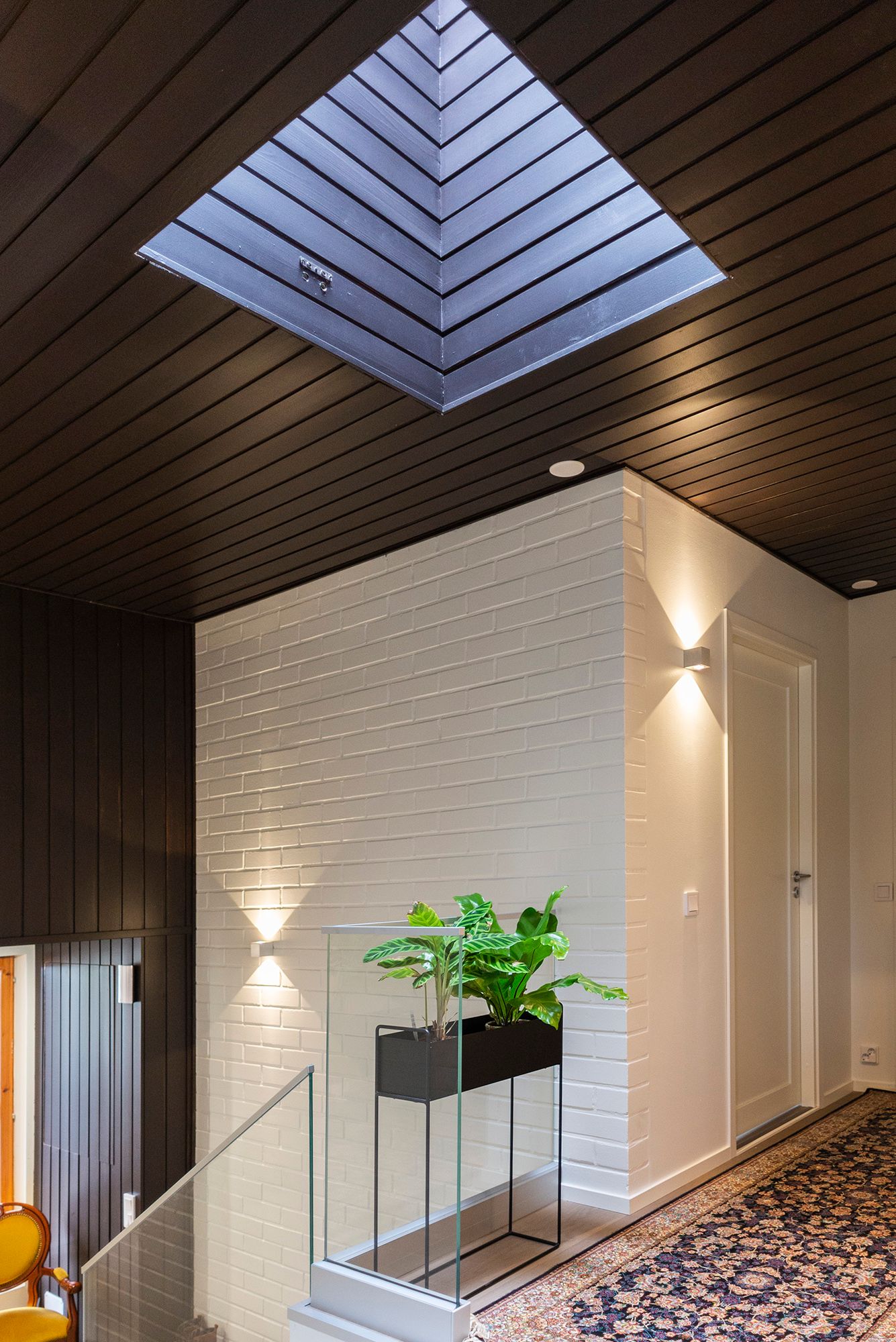 Entrance illuminated by CUBIC wall lamps.