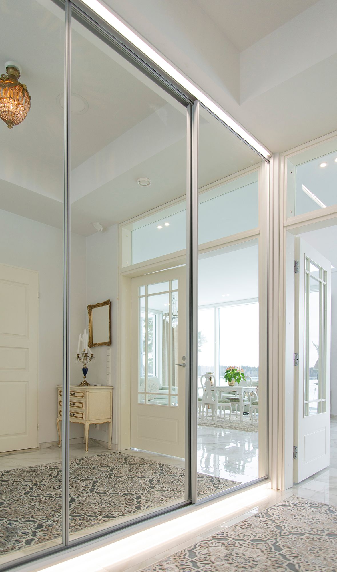 Led strips at the base of the hallway cupboard and above the mirror. Illuminate with beautiful indirect and soft light. Ledstore.fi