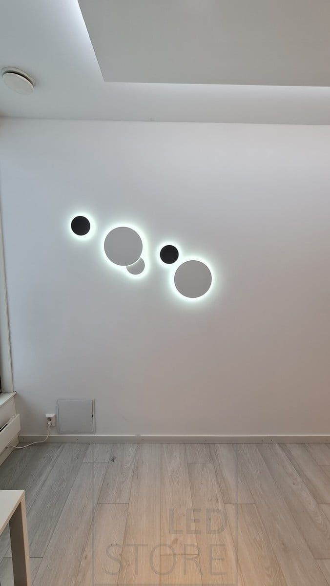 A set for the wall made with the ECLIPSE wall lamp. The lamp illuminates indirectly through the wall and the color temperature of the light is adjustable. Ledstore.fi