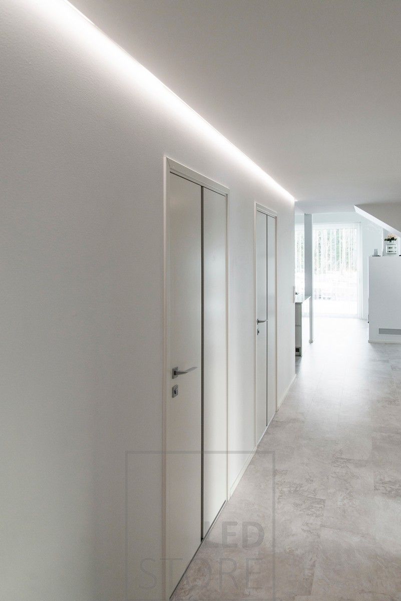A corridor beautifully lit with indirect light. Led strip in aluminium profile mounted in the groove between the ceiling and the wall. Ledstore.fi