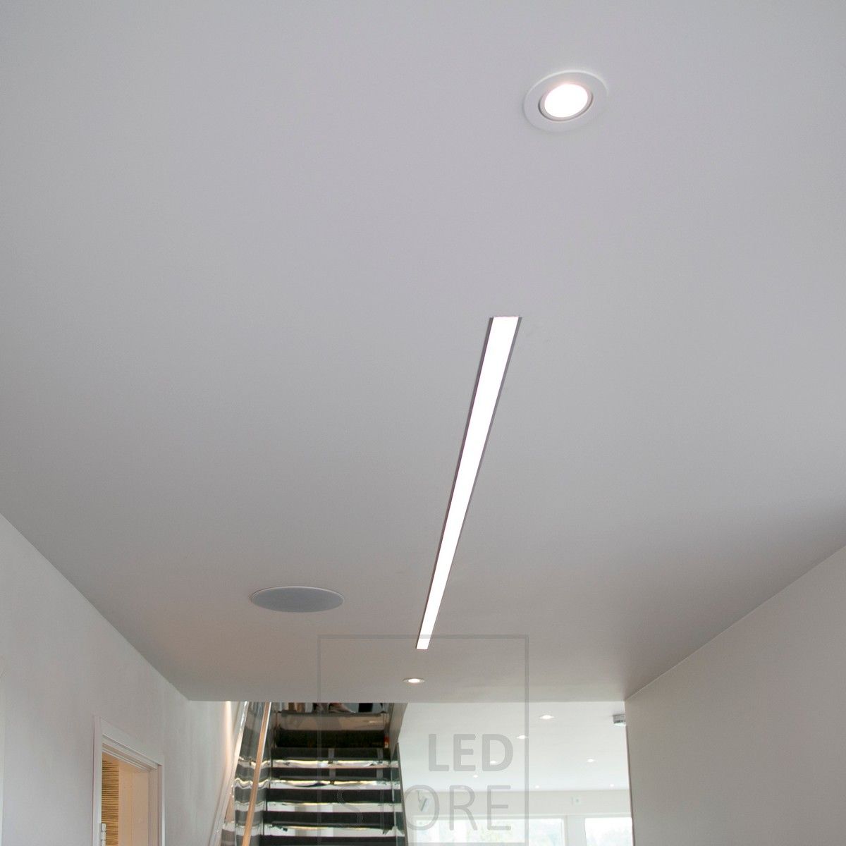 Wide recessed profile with two LED strips combined with recessed spots. Ledstore.fi
