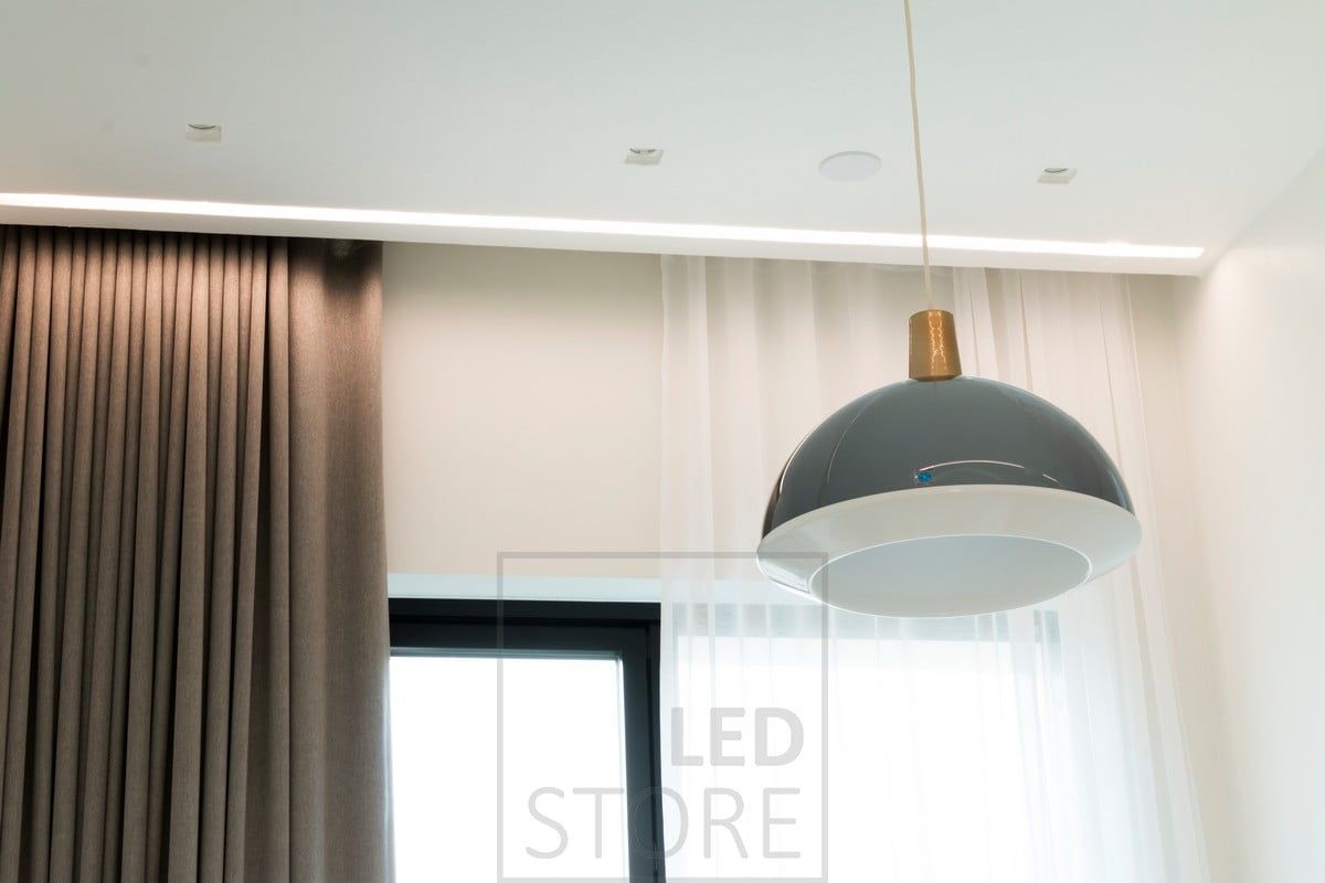 In the bedroom, the wide flush profile next to the curtain rails has LED strips creating atmospheric indirect light. Ledstore.fi