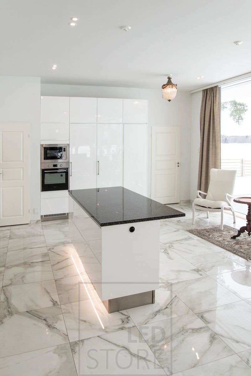 LED ribbon highlighting the kitchen island. Spotlights on the ceiling as general lighting. Ledstore.fi