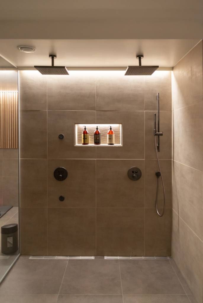 Indirect LED strip lighting on a shower wall. LedStore.fi