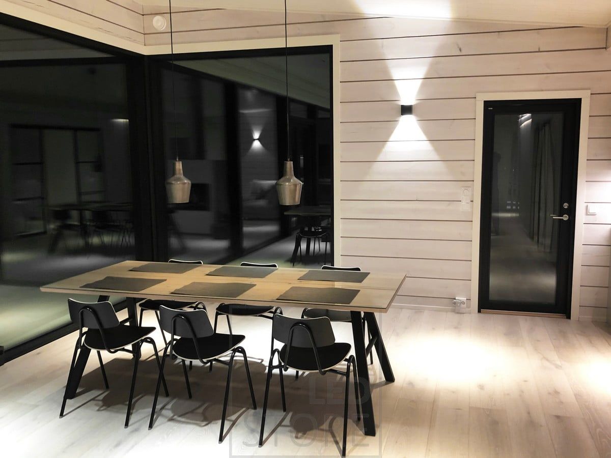 Black LED wall lamp FUNK on the wall in the dining room creating indirect mood lighting. Ledstore.fi