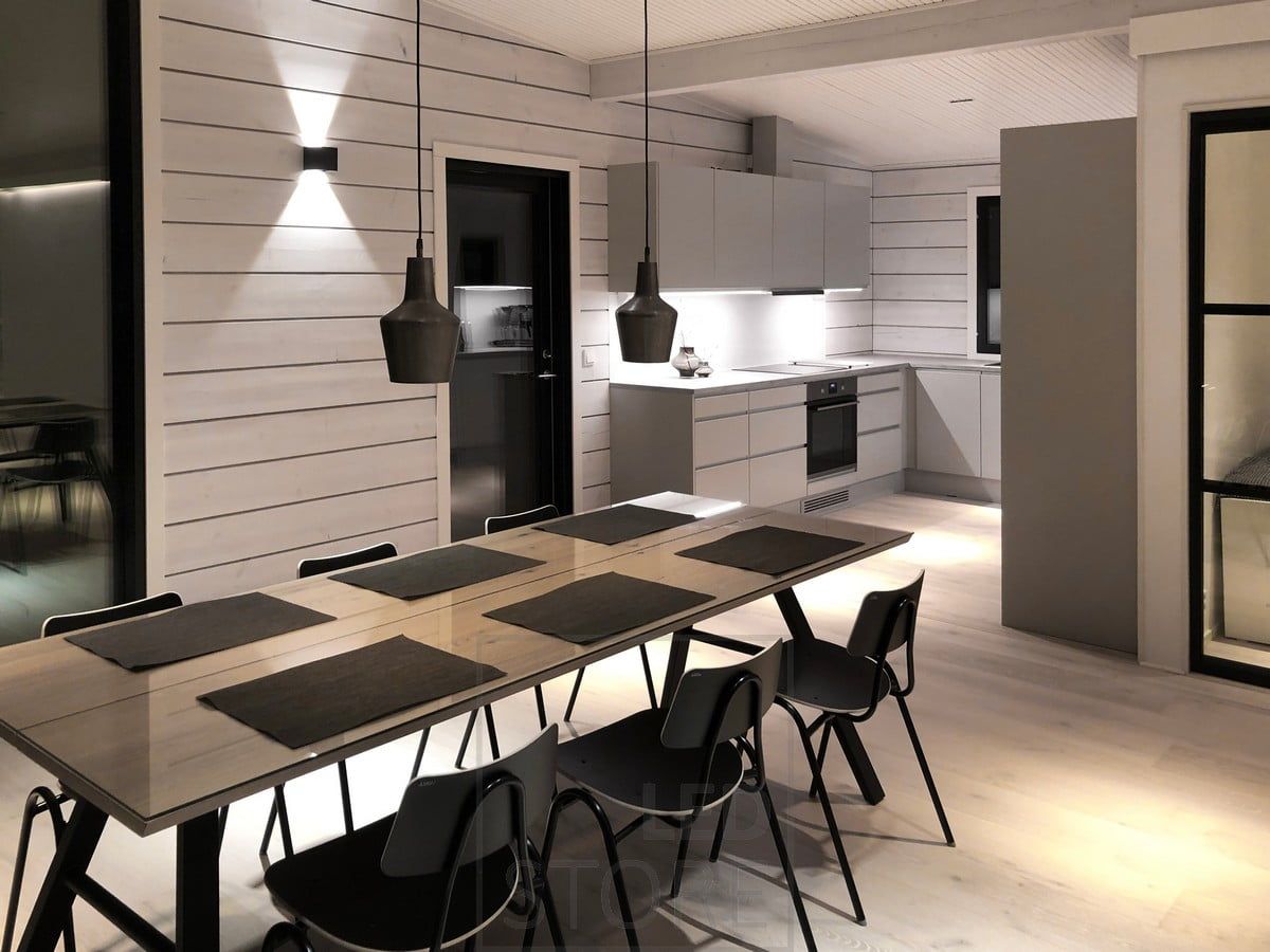 The black FUNK wall lamp illuminates the living room and dining room with atmospheric light through the wall. Ledstore.fi