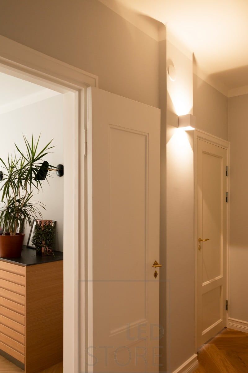 Inside, the white FUNK wall lamp illuminates the corridor with atmospheric light. The lamp is suitable for both outdoor and indoor use. Ledstore.fi