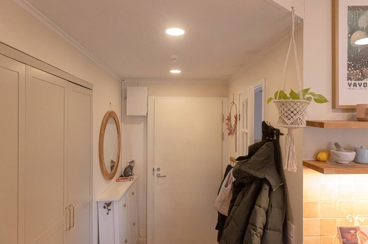 Two round LED panels flush mounted in the ceiling of the hallway.