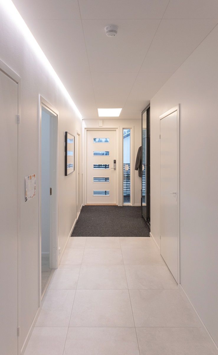 LED strip light at the edge of a drop-down groove in a vestibule.