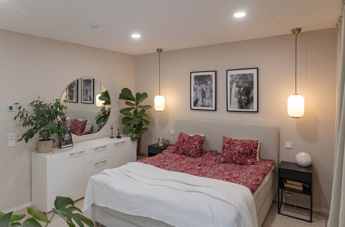 Small round led panels on the bedroom ceiling. Additional pendant lights on both sides of the bed.