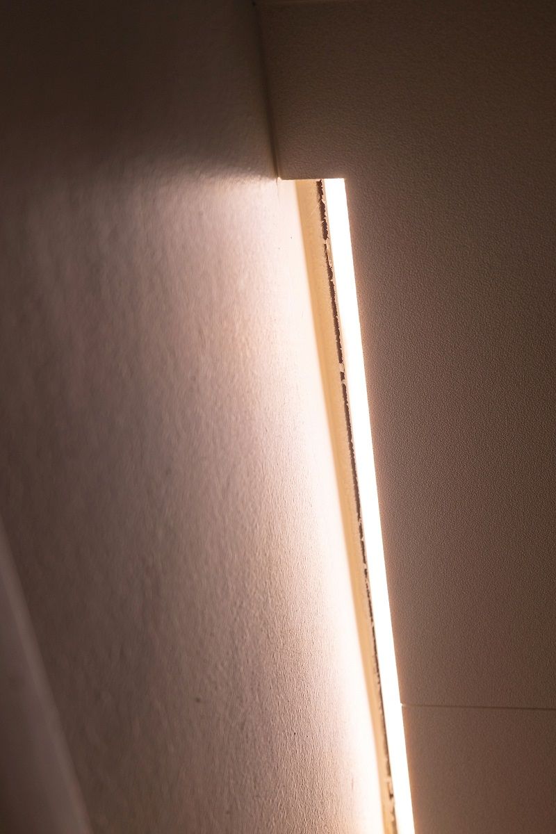 LED strip in the recess between the recess and the wall.