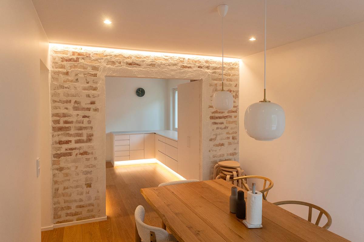 The LED strip highlights the texture of the wall.