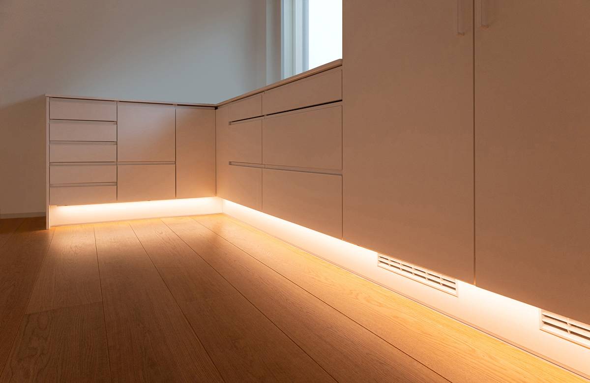 A light in the kitchen baseboard that shines down onto the floor.