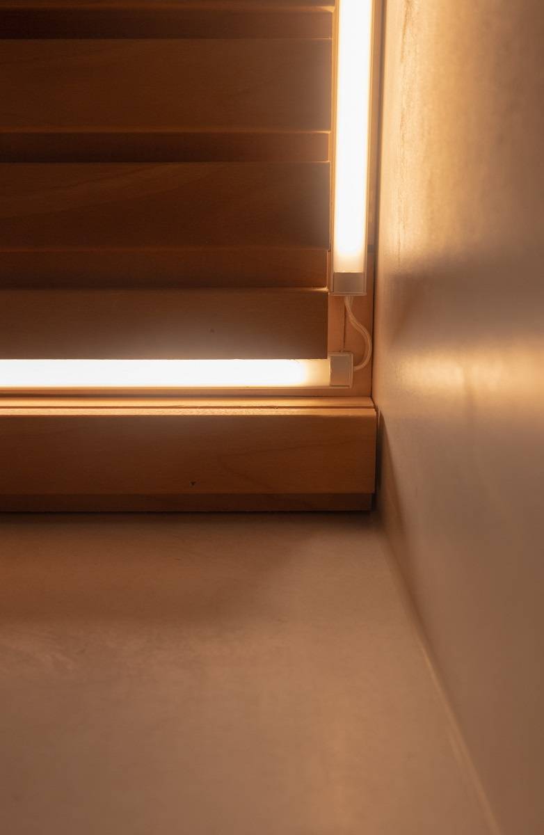 Close-up of LED strip installation on the bathroom ceiling.