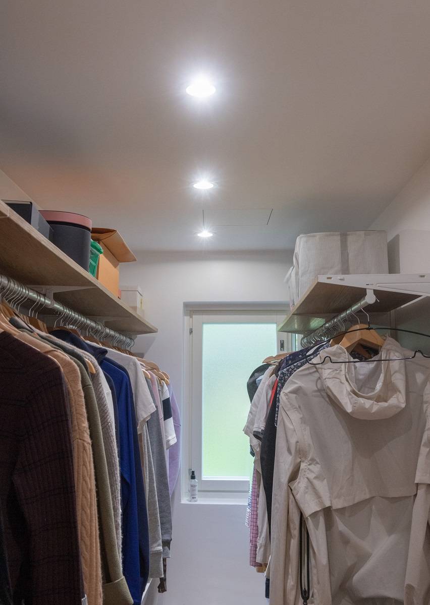 Three spotlights installed in a row in the center of the walk-in closet ceiling.