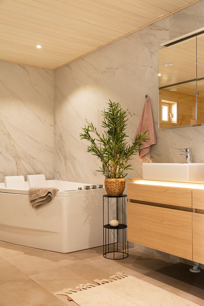 Bathroom spotlight in the ceiling and sink fixture with LED strip milled into the plane to illuminate downwards with soft light. Ledstore.fi
