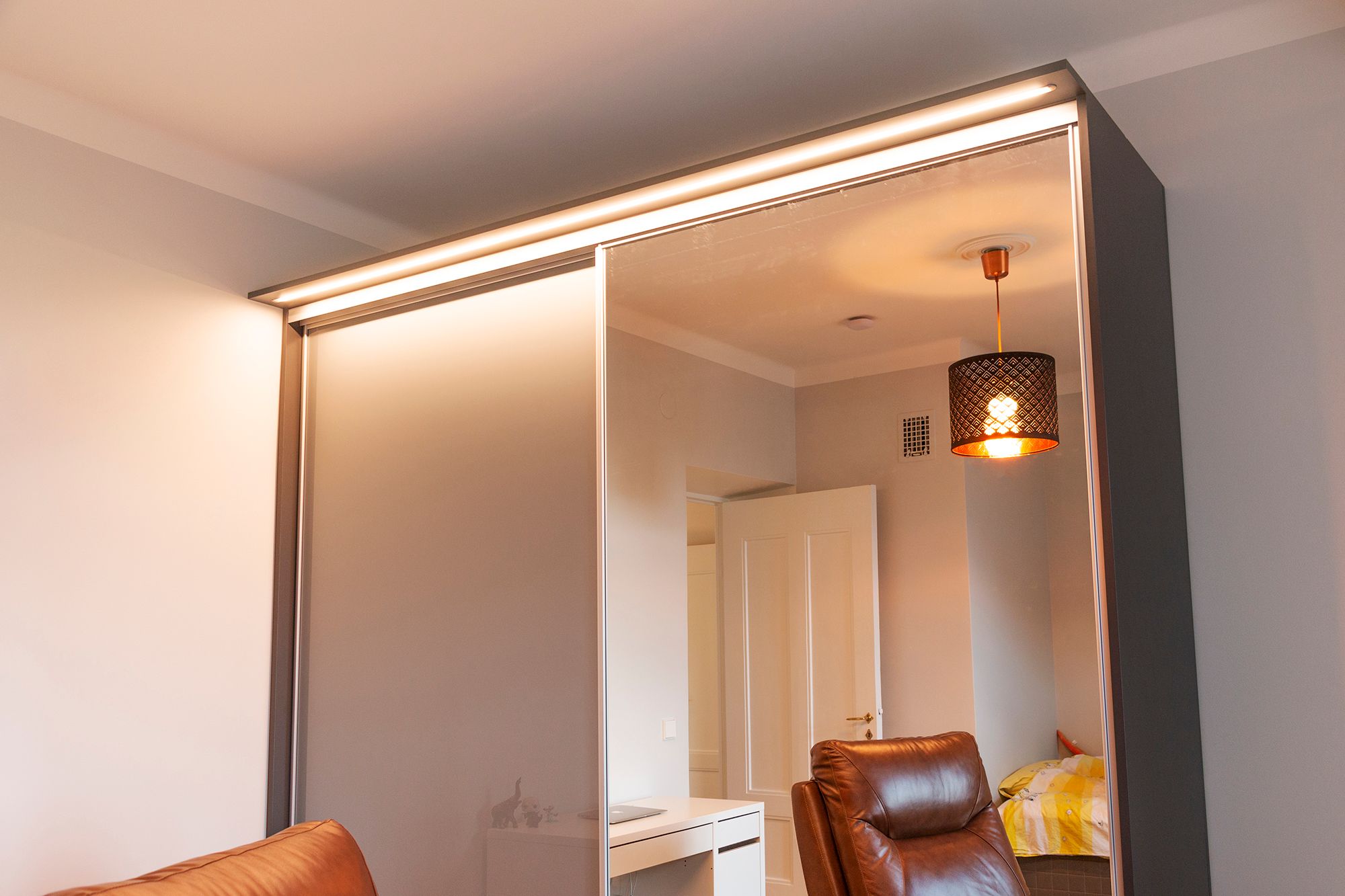 Led ribbon in a narrow flush profile in a box built on top of a cabinet. The light illuminates well the hallway and the cabinet and its contents. Ledstore.fi