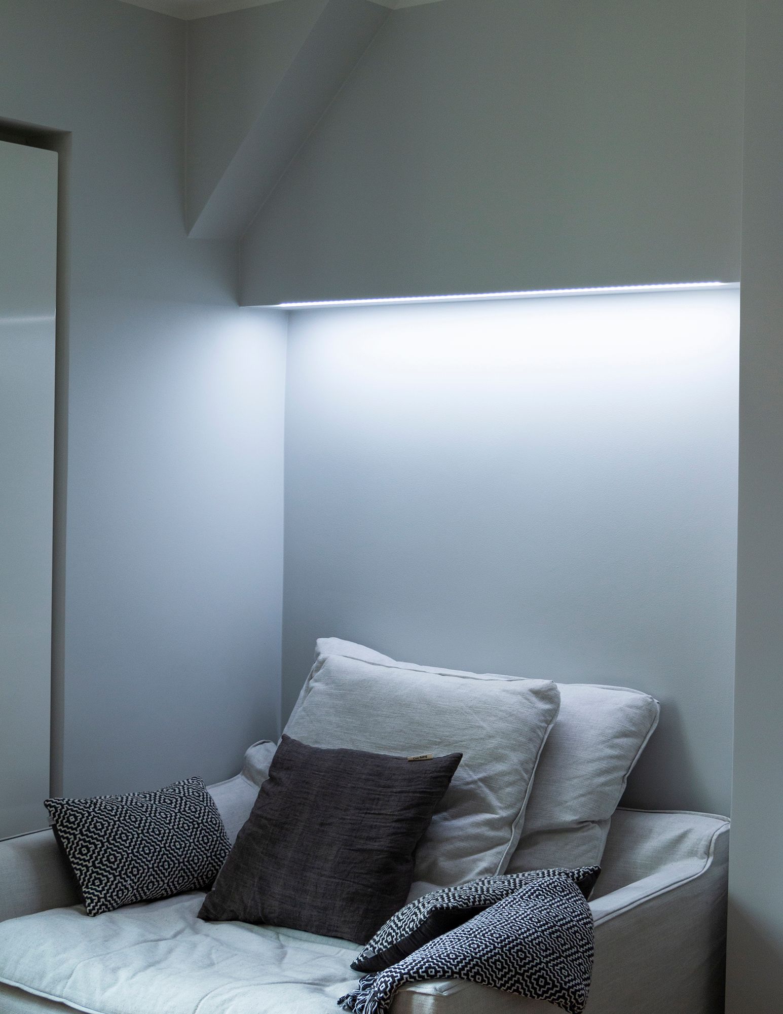 In the bedroom, colour temperature adjustable mood lighting behind the bed, mounted on the base of the wardrobe. In the picture, the colour temperature is set to a cold tone. Ledstore.fi