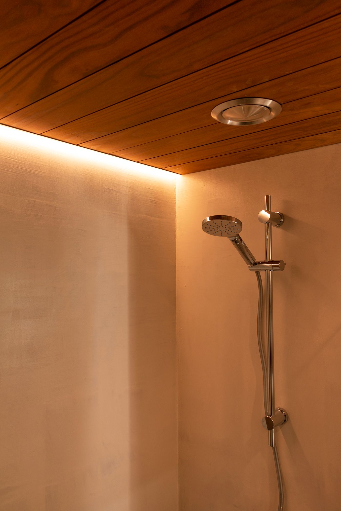 In a corner profile flush with the ceiling, a led strip illuminates the shower. Ledstore.fi