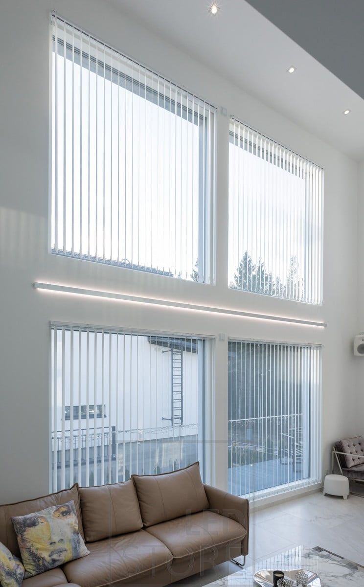 LED strip lights in a bi-directional wall profile to accentuate the height of the living room and the windows. Profile and LED strips available made to measure according to your own dimensions. Circular led spots in the ceiling for general lighting. Ledstore.fi