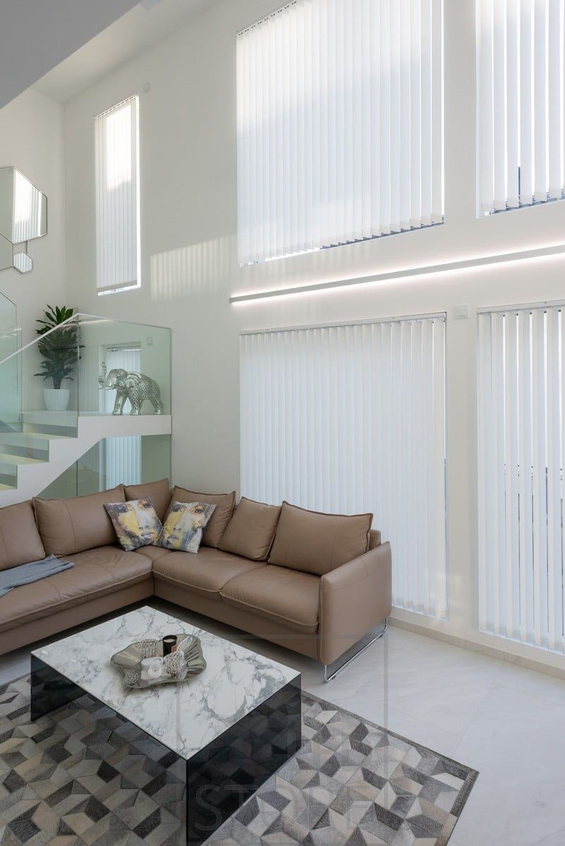 LED strip lights in a bi-directional wall profile to accentuate the height of the living room and the windows. Profile and LED strips can be ordered made to measure and ready for installation. The bi-directional profile is also available in black. Ledstore.fi