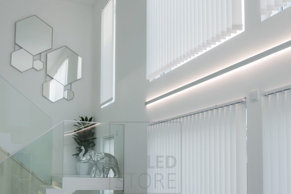 LED strip lights in a bi-directional wall profile to accentuate the height of the living room and the windows. Profile and LED strips can be ordered made to measure and ready for installation. Ledstore.fi