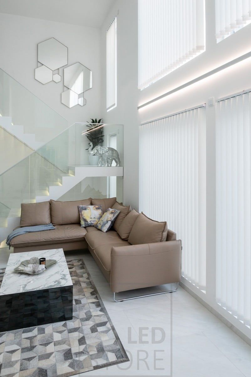 LED strip lights in a bi-directional wall profile to accentuate the height of the living room and the windows. Ledstore.fi