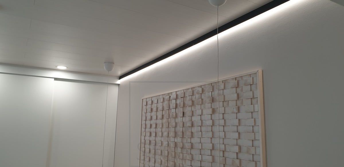 In the bedroom, a black wall profile replacing the ceiling moulding, with an LED strip on the profile illuminating the wall for indirect mood lighting. Ledstore.fi