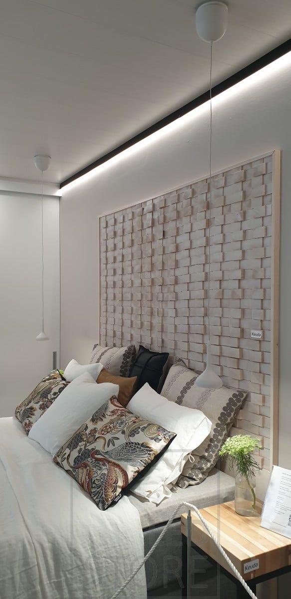 Behind the bed, a black wall profile at the ceiling border replacing the ceiling moulding. Led strip light illuminating downward indirect light through the wall. Ledstore.fi