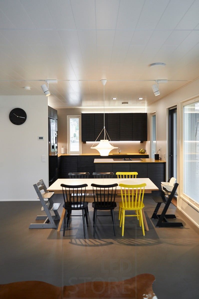 Three-phase track general lighting, atmospheric indirect lighting with led strips on top of the cabinets in the kitchen. LED strip on the bottom of the upper cabinets illuminating the worktop. Ledstore.fi
