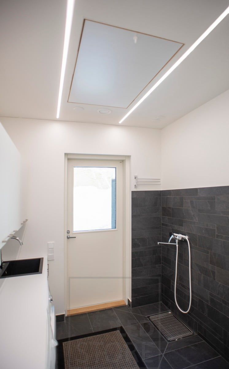 Led strips in recessed profiles in the ceiling creating general lighting in the space. Ledstore.fi