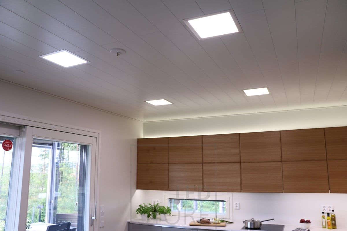 Panel lights on the ceiling, indirect lighting on the cabinets and LED strip lighting on the kitchen level. Ledstore.fi