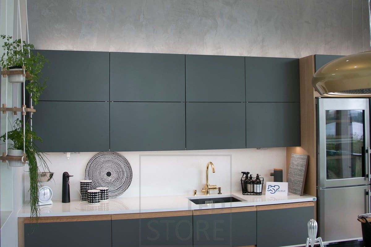 Atmospheric indirect lighting on top of cabinets combined with a LED strip mounted on the worktop. Ledstore.fi